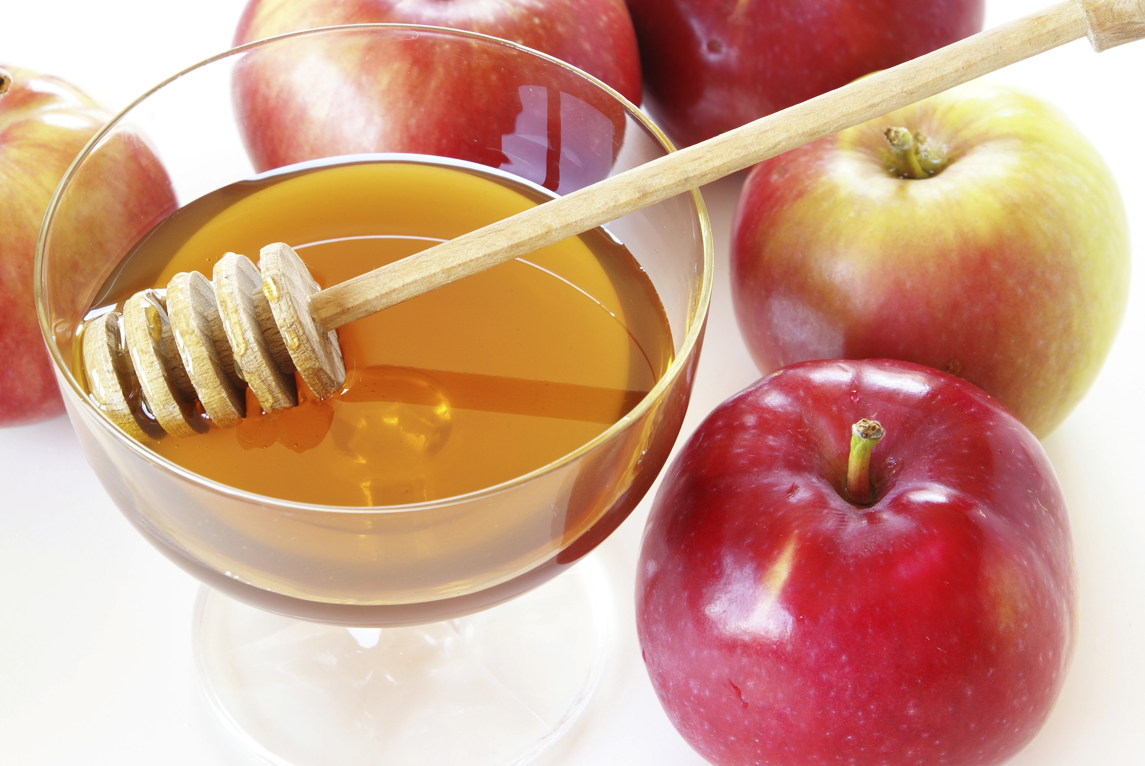Whole apples and bowl of honey